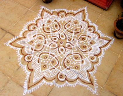 Rangoli: Dotted kolam in white with  Red kaavi