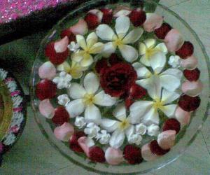 Rangoli: Glass bowl filled with water and flowers  