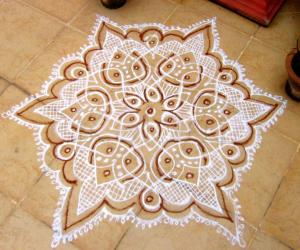 Rangoli: Dotted kolam in white with  Red kaavi