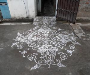  Fishes on lotus. Kolam in white.