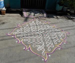 Rangoli: Chikku kolam. Swasthik kolam with leaf like out line.