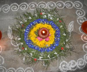 Rangoli: Karthigai decoration with arugampul, sangupoo & yellow poo.
