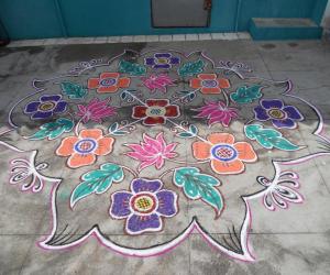 Flower kolam with lotus & leaves in different style.