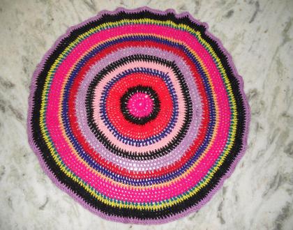 Crochet work. Round shaped table mat.