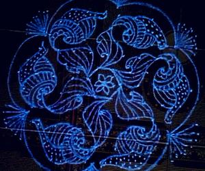 Rangoli: A flower with shell kolam 11-6 interlaced dots.