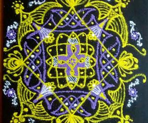 Rangoli: A chikku kolam with 11-1 straight dots with colours.