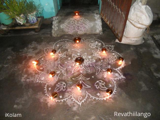 Rangoli: karthigai kolam in white.
