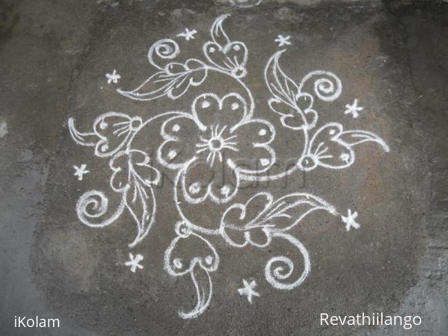 Rangoli: A small flower kolam. Rangoli: A small flower kolam.