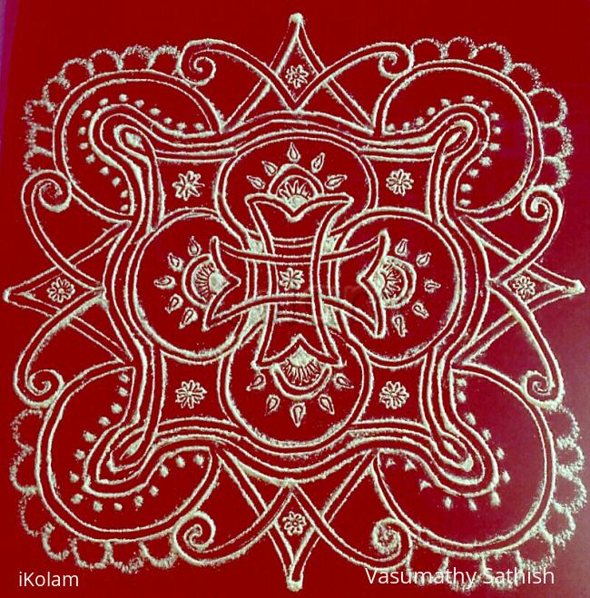 Rangoli: Iyengar padi  kolam with rice flour on red plastic cover