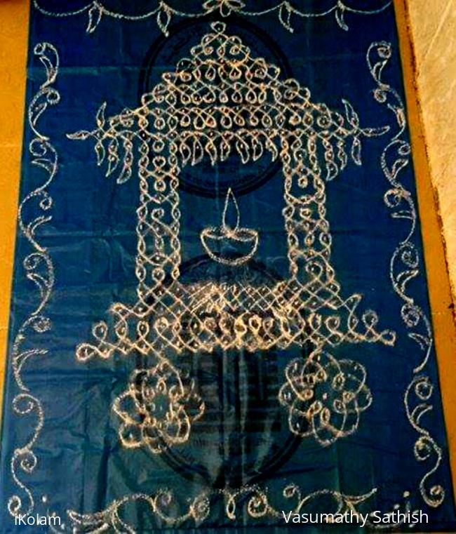 Rangoli: Ther kolam in chikku pattern with rice flour Rangoli: Ther kolam in chikku pattern with rice flour