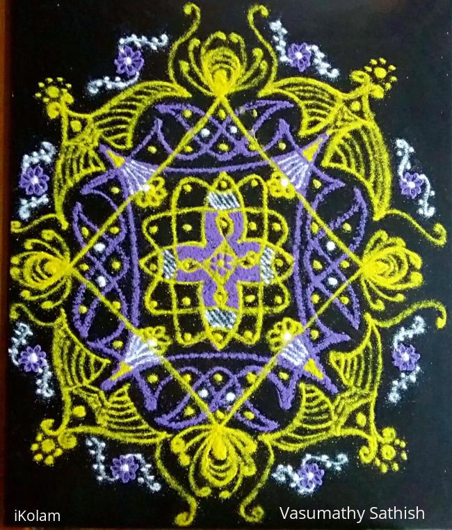Rangoli: A chikku kolam with 11-1 straight dots with colours.